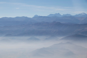 Fototapeta na wymiar Misty blue Andean mountain landscape background