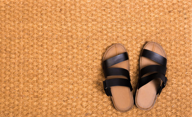 Cleaning foot carpet with sandals welcome home