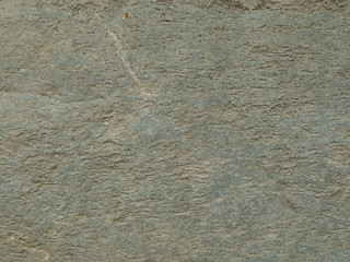 Fragment of rough gray stone surface as texture