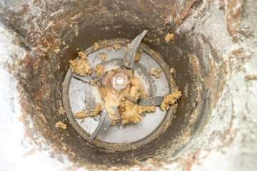 metal mixer with shredder and dough remains photographed from above