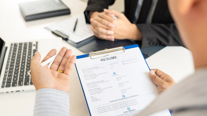 Job Interview and hiring concept, Appointment candidate Business man explaining about his profile and answer to Human resources manager sitting at a table opposite in the office.
