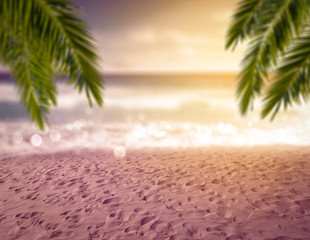 Summer background of beach and ocean and green leaves of palms. 