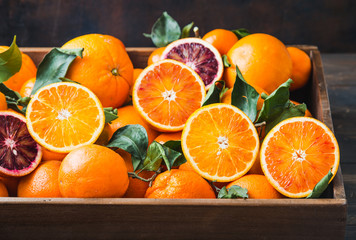 Oranges citrus fruits background in wooden box.