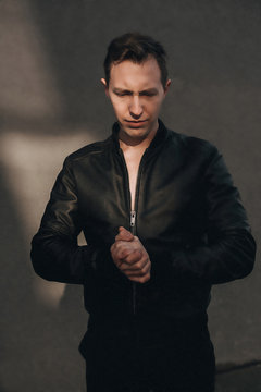 Stylish fashion young Man portrait with leather jacket on black background