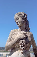 Sculpture of a girl with a bunch of grapes