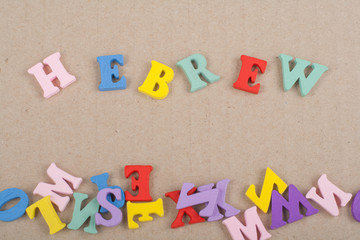 HEBREW word on paper background composed from colorful abc alphabet block wooden letters, copy space for ad text. Learning english concept.