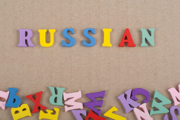 Russia word on paper background composed from colorful abc alphabet block wooden letters, copy space for ad text. Learning english concept.