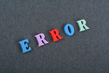 ERROR word on black board background composed from colorful abc alphabet block wooden letters, copy space for ad text. Learning english concept.