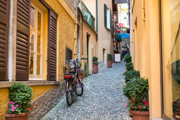 Fototapeta na wymiar Old picturesque street with amazing view in beautiful Bellagio, Como lake, Italy