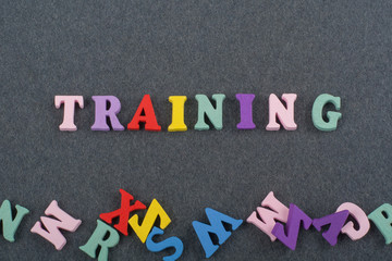 TRAINING word on black board background composed from colorful abc alphabet block wooden letters, copy space for ad text. Learning english concept.