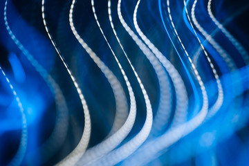 Colorful pattern of blue dynamic neon lines. Modern background. Art concept of lighting effects.