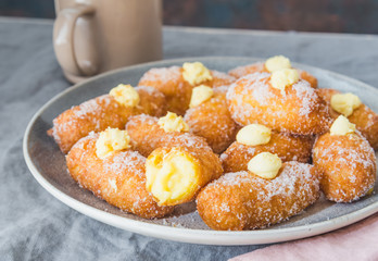 Italian pastry, frittelli. Fried sweets filled with pastry cream.