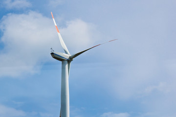 wind power plant on the background of bright cloudy sky. wind generator close-up. green electricity, alternative energy