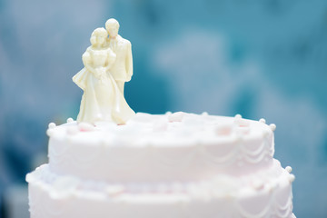 Beautiful wedding cake with figurines from white chocolate on top