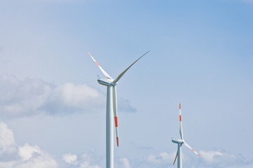 wind power plant on the background of bright cloudy sky. wind generator close-up. green electricity, alternative energy