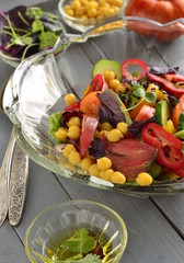 Salad with chickpeas, fresh vegetables and black sesame, vertical