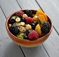 Oat flakes with various berries, hazelnuts and honey