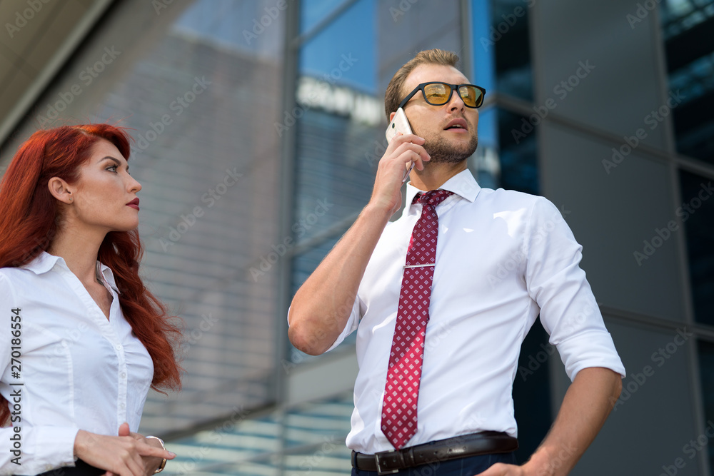 Wall mural business people using a mobile phone