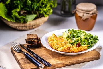 Omelet with cheese and salad
