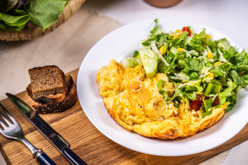 Omelet with cheese and salad