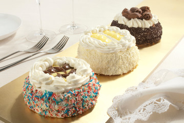 Three Chantilly little dessert, monoportion cake decorated with chocolate and cream