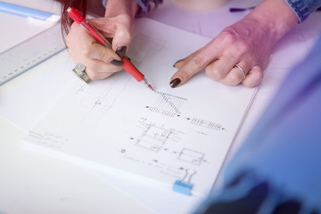 Female Architecture teacher at work. Female professor explain architectural projects to students.