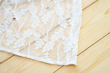 White lace with small flowers on the wood background