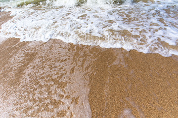 sea wave foam sand gold color. close up