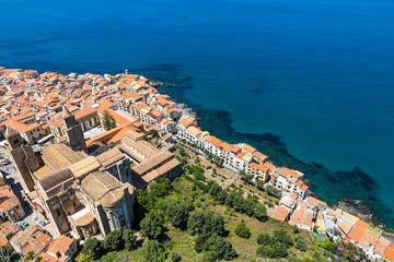 Obraz premium Aerial view of Cefalu old town, Sicily, Italy. It is one of the major tourist attractions in Sicily. Picturesque view from Rocca di Cefalu. Cefalu Cathedral (Duomo di Cefalu) on the foreground