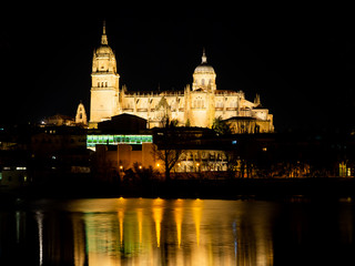 Naklejka na ściany i meble Long exposure night view of the Cathedral and Enrique Estevan bridge in Salamanca (Spain)