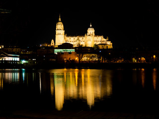 Fototapeta na wymiar Long exposure night view of the Cathedral and Enrique Estevan bridge in Salamanca (Spain)