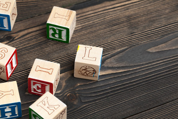 Alphabet blocks ABC on wooden table.