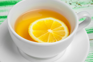 Black tea on green wooden background