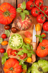 colorful tomato and basil with board and knife