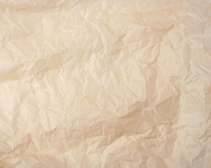 crumpled brown baking parchment paper, full frame