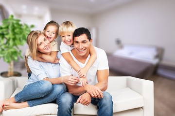 Young  family at home smiling at camera