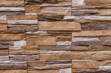 Texture of the stone wall. Panel of stones for finishing the facade of the building and interior design of the house. Background for design and decoration.