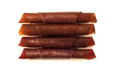 Top view of fruit leather rolls isolated on white background
