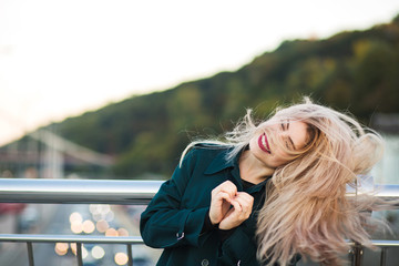 Emotional pretty woman showing heart gesture from her fingers. Empty space