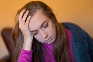 Young woman at home suffering from headache, emotions and stress