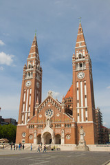 Fototapeta na wymiar The Votive Church and Cathedral of Our Lady of Hungary is a twin-spired church in Szeged. It lies on Dm square beside the Dmtr tower. Construction began in 1913, finished in 1930