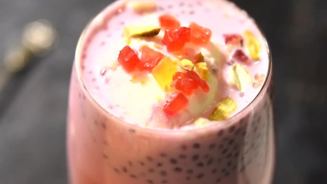 Falooda / Faluda is a popular Indian dessert - Strawberry and Mango flavoured which has Ice cream, noodles, sweet basil seeds and nuts, clip/footage