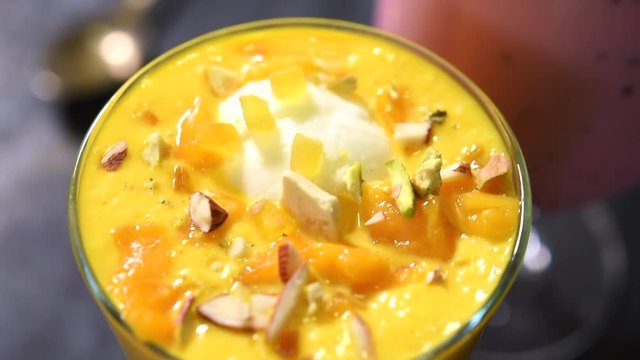 Falooda / Faluda is a popular Indian dessert - Strawberry and Mango flavoured which has Ice cream, noodles, sweet basil seeds and nuts, clip/footage