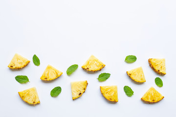 Pineapple slices with mint on white