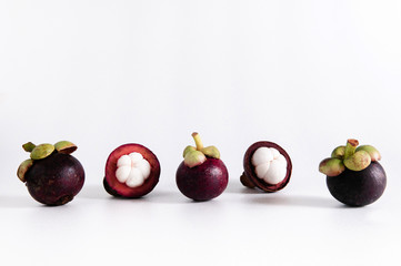 Fresh Thai mangosteens half cut isloated on white background