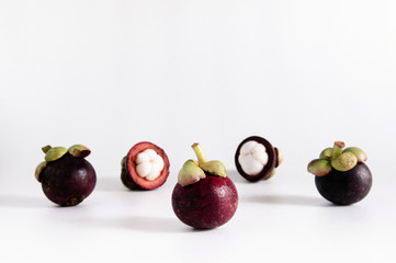 Fresh Thai mangosteens half cut isloated on white background