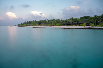 long time exposure of the maledivian beach with palmes and villas