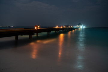 Obraz premium dock at night with various colored lights
