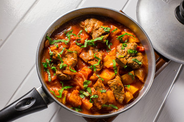 Stuffed meat with potatoes in a tomato sauce on a boiler