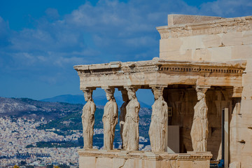 Obraz premium Lateral view of the Loggia of the Caryatids with town background, Athens
